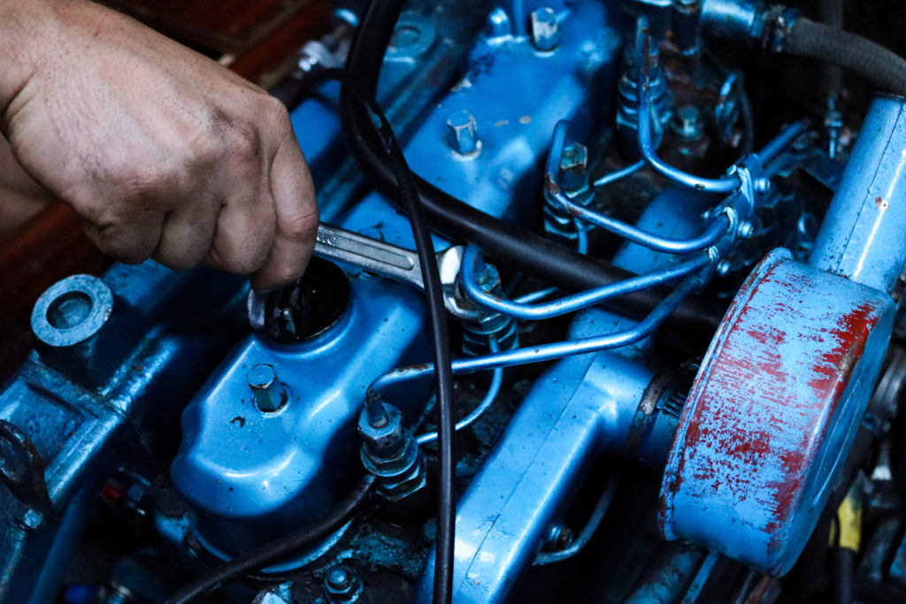 Marine boat engineer working on a sailing or motorboat engine